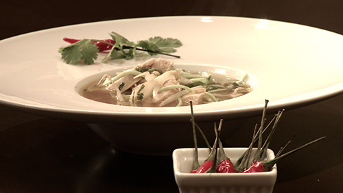 Soupe au poulet aigre et épicée parfumée à l’ail